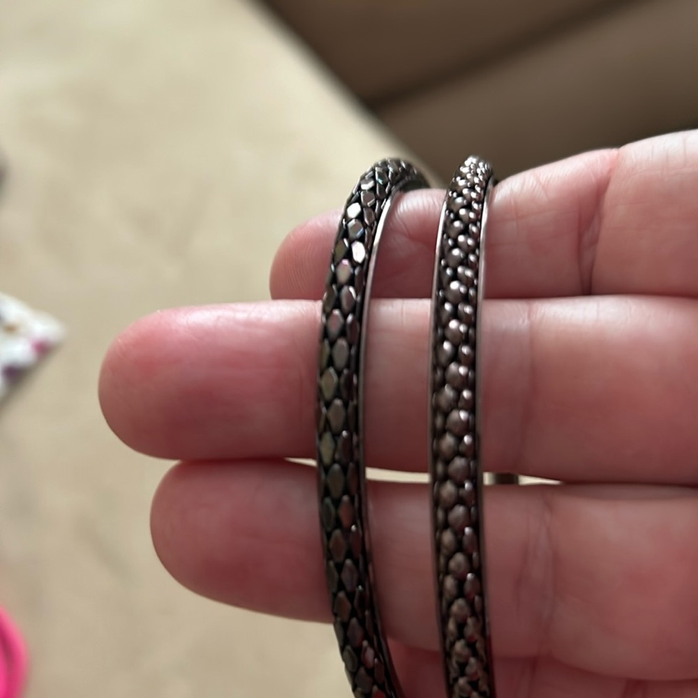 Two bronze bangle bracelets, different styles